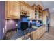 Kitchen features built-in desk and ample wood cabinetry at 8174 Inca Rd, Larkspur, CO 80118
