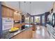 Open concept kitchen with island, granite counters and hardwood floors at 8174 Inca Rd, Larkspur, CO 80118