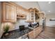Kitchenette with light wood cabinets, granite countertops, and stainless steel appliances at 8174 Inca Rd, Larkspur, CO 80118
