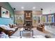 Living room with stone fireplace and view into dining area at 8174 Inca Rd, Larkspur, CO 80118