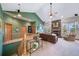 Spacious living room with a fireplace and wood staircase at 8174 Inca Rd, Larkspur, CO 80118