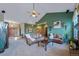 Bright and airy living room with high ceilings and green accent wall at 8174 Inca Rd, Larkspur, CO 80118