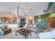 Open living room with hardwood floors and access to kitchen at 8174 Inca Rd, Larkspur, CO 80118