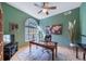 Home office with a large window, wood desk, and wood floors at 8174 Inca Rd, Larkspur, CO 80118