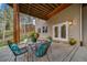 Relaxing patio area with seating and views of the woods at 8174 Inca Rd, Larkspur, CO 80118