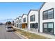 Contemporary row of townhomes showing a sleek modern design and well-kept lawns in a vibrant neighborhood setting at 1907 W Elk Pl, Denver, CO 80211