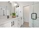 Stylish bathroom with dual sink vanity, black fixtures, and a glass-enclosed shower at 1907 W Elk Pl, Denver, CO 80211