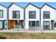 A modern townhome featuring sleek architecture and a well-manicured front yard at 1907 W Elk Pl, Denver, CO 80211