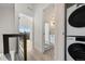 Bright hallway featuring a modern bathroom with a patterned tile floor and laundry area at 1907 W Elk Pl, Denver, CO 80211