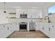 Modern kitchen featuring stainless steel appliances, white cabinets, and hardwood floors at 1907 W Elk Pl, Denver, CO 80211