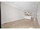 Open-concept living area with hardwood floors and a bright kitchen space at 1907 W Elk Pl, Denver, CO 80211