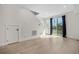 Open-concept living space with hardwood floors, staircase, and access to the outside at 1907 W Elk Pl, Denver, CO 80211