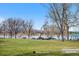 Picturesque park view with picnic tables, lush grass, and tranquil lake with the mountains in the background at 1907 W Elk Pl, Denver, CO 80211