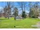 View of a park with a playground, green grass and mature trees, perfect for outdoor activities and relaxation at 1907 W Elk Pl, Denver, CO 80211