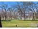 Picturesque park view with picnic tables, lush grass, and tranquil lake with the mountains in the background at 1907 W Elk Pl, Denver, CO 80211