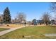 Sunny playground at César Chávez Park features modern play equipment and mature trees at 1907 W Elk Pl, Denver, CO 80211