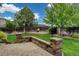 Landscaped backyard with patio area and a fire pit with Adirondack chairs at 8286 W 108Th Pl, Broomfield, CO 80021