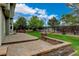 Backyard features lush green lawn, mature trees, and a large patio area at 8286 W 108Th Pl, Broomfield, CO 80021