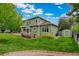 Well-maintained backyard features lush green grass, mature trees, and a storage shed at 8286 W 108Th Pl, Broomfield, CO 80021