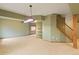 An open basement area with neutral carpet, wet bar, and stairs at 8286 W 108Th Pl, Broomfield, CO 80021