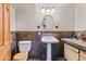 Bathroom featuring a pedestal sink, and unique tile backsplash and flooring at 8286 W 108Th Pl, Broomfield, CO 80021