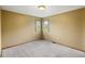 A carpeted bedroom with neutral-colored walls and two windows providing natural light at 8286 W 108Th Pl, Broomfield, CO 80021