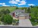 Inviting home with lush landscaping, a brick driveway, and an attached three-car garage offers curb appeal at 8286 W 108Th Pl, Broomfield, CO 80021