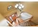 View from the stairs looking down into the foyer with front door and chandelier at 8286 W 108Th Pl, Broomfield, CO 80021