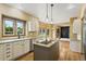 Bright kitchen with white cabinets, granite countertops, and stainless steel appliances at 8286 W 108Th Pl, Broomfield, CO 80021