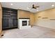 Spacious living room with built-in shelves and a cozy white-brick fireplace at 8286 W 108Th Pl, Broomfield, CO 80021