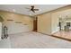 Spacious living room next to the kitchen with carpet, and a white brick fireplace at 8286 W 108Th Pl, Broomfield, CO 80021