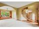 Spacious living room featuring carpet flooring, an archway to an adjacent room, and a staircase at 8286 W 108Th Pl, Broomfield, CO 80021