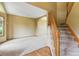 Bright, open living room with staircase, carpet flooring, wood floors and archway, creating a spacious and welcoming ambiance at 8286 W 108Th Pl, Broomfield, CO 80021