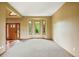 Bright living room with carpet flooring, a bay window offering views, and a wood front door at 8286 W 108Th Pl, Broomfield, CO 80021