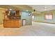 A well-appointed wet bar with wooden cabinets, backsplash, and a mini-fridge in the basement at 8286 W 108Th Pl, Broomfield, CO 80021