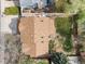 This aerial shows a large roof and a small yard partially enclosed by a white fence, topped with neighborhood rooftops at 9911 Perry Ct, Westminster, CO 80031