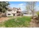 This beautiful yard with a deck, mature trees, and a white fence creates a serene outdoor space, perfect for relaxing at 9911 Perry Ct, Westminster, CO 80031