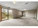 Large finished basement with sliding door access to the backyard and built-in shelves at 9911 Perry Ct, Westminster, CO 80031