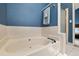 This relaxing bathroom is equipped with a large soaking tub and a shower at 9911 Perry Ct, Westminster, CO 80031