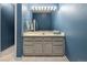 Well-lit bathroom with a white countertop, gray cabinets, and a big mirror at 9911 Perry Ct, Westminster, CO 80031