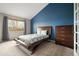 Stylish bedroom with a modern bed frame, dresser, and a large window at 9911 Perry Ct, Westminster, CO 80031