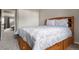 Bedroom with under-bed storage, gray carpet, and a view to the hallway and adjacent bedroom at 9911 Perry Ct, Westminster, CO 80031