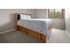 Bedroom with gray carpet, a bed with storage drawers, and a window with outdoor view at 9911 Perry Ct, Westminster, CO 80031