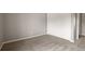Bright, empty room with new carpet and a sliding door closet at 9911 Perry Ct, Westminster, CO 80031