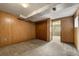 Cozy bedroom featuring wood paneling, a closet, and an adjoining room, ideal for relaxation at 9911 Perry Ct, Westminster, CO 80031