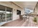 A covered deck is the perfect extension of indoor living with a glass slider, and patio furniture for outdoor relaxation at 9911 Perry Ct, Westminster, CO 80031