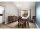 Bright dining room featuring wood floors and an antique buffet table near a window at 9911 Perry Ct, Westminster, CO 80031
