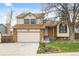 A two-story home featuring a well-kept lawn, mature trees, and brick accents, situated in a peaceful residential area at 9911 Perry Ct, Westminster, CO 80031