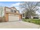 Charming two-story home featuring a well-maintained lawn, mature trees, and attached two-car garage, located at 9911 at 9911 Perry Ct, Westminster, CO 80031