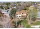 A house with a brown roof, white siding and a nice back deck is surrounded by trees in a residential neighborhood at 9911 Perry Ct, Westminster, CO 80031
